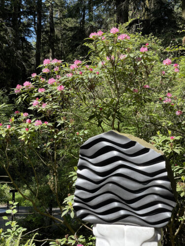 We Are Water by Sue Taves with rhododendrons in bloom at Price Sculpture Forest