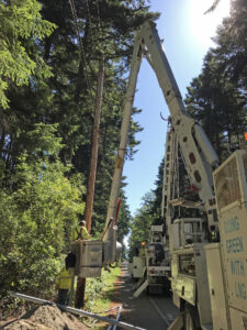 Puget Sound Energy PSE boom lift installing electricity at Price Sculpture Forest