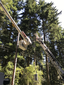 Puget Sound Energy PSE installing transformer on pole at Price Sculpture Forest
