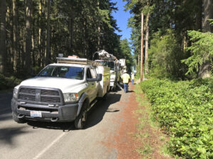 Puget Sound Energy PSE team and trucks connecting electricity at Price Sculpture Forest