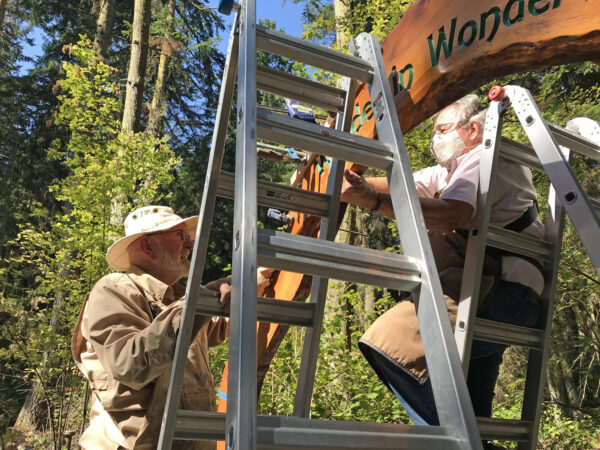 Ken Price and Michael Hauser assembling Wonder In Wonder arch at Price Sculpture Forest Coupeville Whidbey Island sculpture park