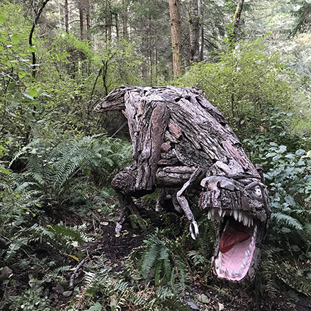 Sculptor Joe Treat sculpture Tyrannosaurus Rex at Price Sculpture Forest sculpture park garden in Coupeville on Whidbey Island