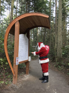 Santa Claus reading entry kiosk at Price Sculpture Forest park garden in Coupeville on Whidbey Island