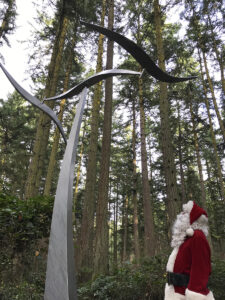 Santa Claus viewing Jeff Kahn's Wind Shear at Price Sculpture Forest park garden in Coupeville on Whidbey Island