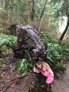 Caela Easton with Joe Treat Tyrannosaurus Rex at Price Sculpture Forest - by Maggie Easton of Oak Harbor WA