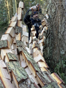 Artist Anthony Heinz May adding wood blocks at Price Sculpture Forest in Coupeville Whidbey Island