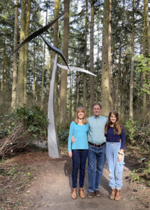 Karen, Scott, and Lydia Price at Price Sculpture Forest in front of Wind Shear by Jeff Kahn