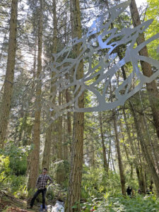 Bob Davenport under Daniella Rubinovitz Flying Fish at Price Sculpture Forest