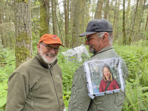 Ken Price and Bob Davenport with photo of Daniella Rubinovitz at installation site of Flying Fish at Price Sculpture Forest