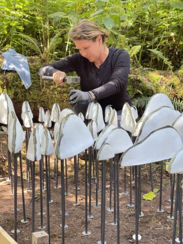 Jenni Ward hammering in rods for Lichen Series Spore Patterns at Price Sculpture Forest