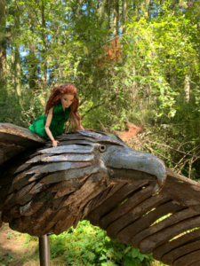 Feminist Barbie flies on Soaring Eagle by Greg Neal at Price Sculpture Forest park garden in Coupeville on Whidbey Island - photo by Liz Jackson