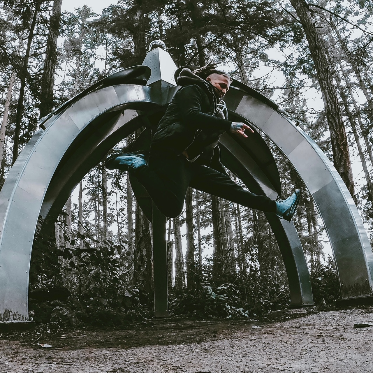 Jamie Webster of Clinton WA jumps for joy in front of Gary Gunderson's Pentillium at Price Sculpture Forest