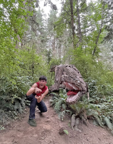 Joh Morrill dancing at T Rex by Joe Treat at Price Sculpture Forest