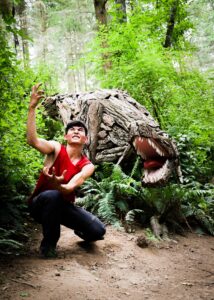 Dancer Joh Morrill at T-Rex by Joe Treat - WANDER WONDER 2022 at Price Sculpture Forest