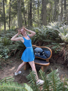 Sophie Powell at orca whale bench in Price Sculpture Forest