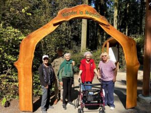 Visitors gathered at the forest entrance with mobility support
