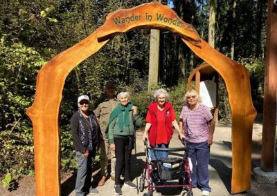 Visitors gathered at the forest entrance with mobility support