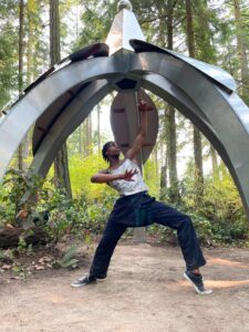 A visitor interacting with an outdoor sculpture