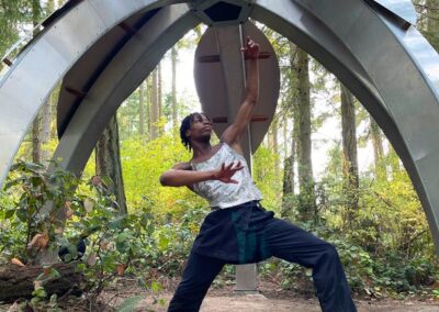 A visitor interacting with an outdoor sculpture