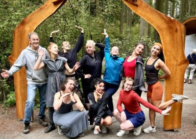 A group of visitors gathered beneath the forest entrance arch