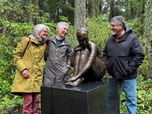 Visitors standing with an outdoor sculpture