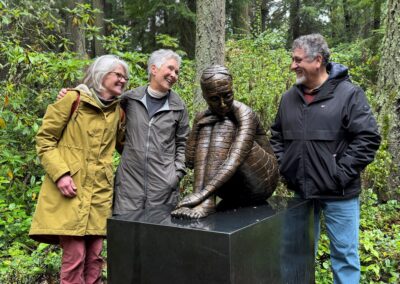 Visitors standing with an outdoor sculpture